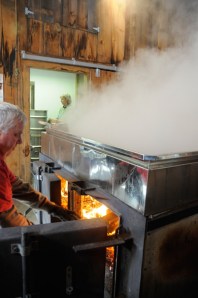 Steve stokes the fire under the evaporator to keep up a steady boil